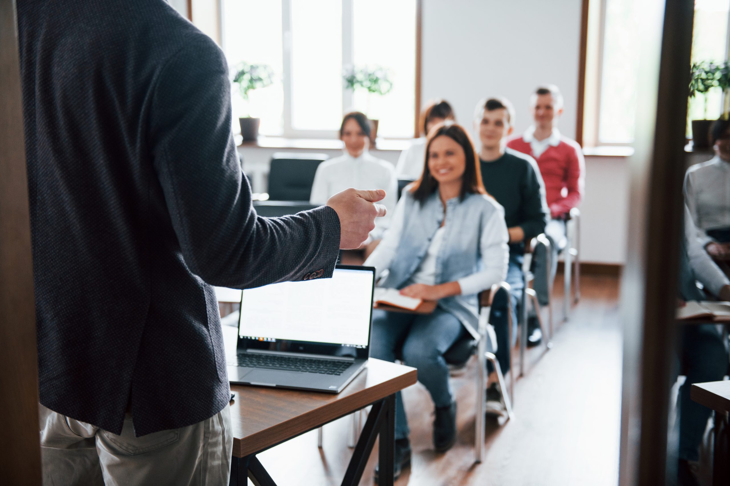 Cheerful mood. Group of people at business conference in modern classroom at daytime Cheerful mood. Group of people at business conference in modern classroom at daytime.